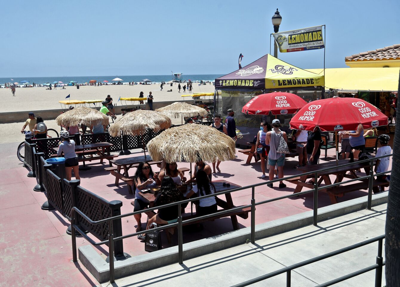 Customers enjoy sit-down food at Zack's near the Huntington Beach Pier on Saturday.
