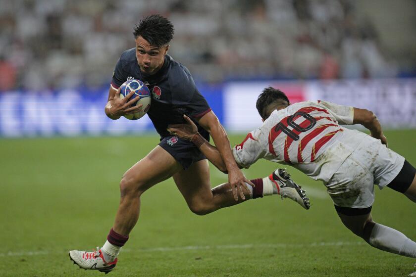 England's Marcus Smith tries to get past Japan's Rikiya Matsuda during the Rugby World Cup Pool D match between England and Japan in the Stade de Nice, in Nice, France Sunday, Sept. 17, 2023. (AP Photo/Daniel Cole)