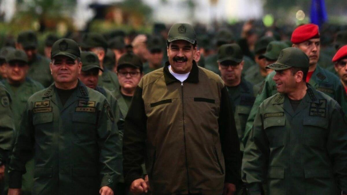 Venezuela President Nicolas Maduro, center, arrives for a meeting with military leaders in Caracas on May 2.