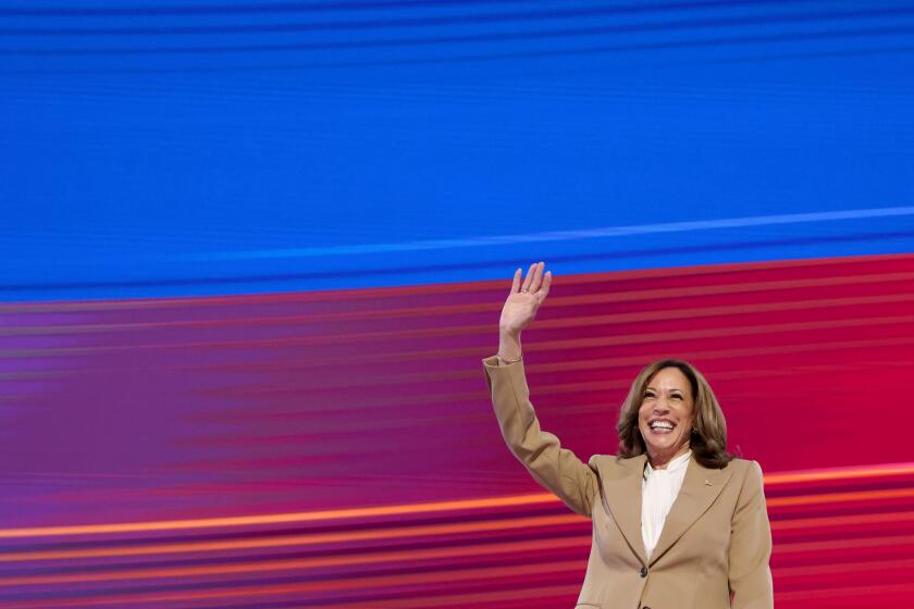 DNC CHICAGO, IL AUGUST 19, 2024 - Democratic presidential nominee Vice President Kamala Harris waves during the 2024 Democratic National Convention at United Center in Chicago on Monday, August 19, 2024 in Chicago, IL. (Robert Gauthier/Los Angeles Times)