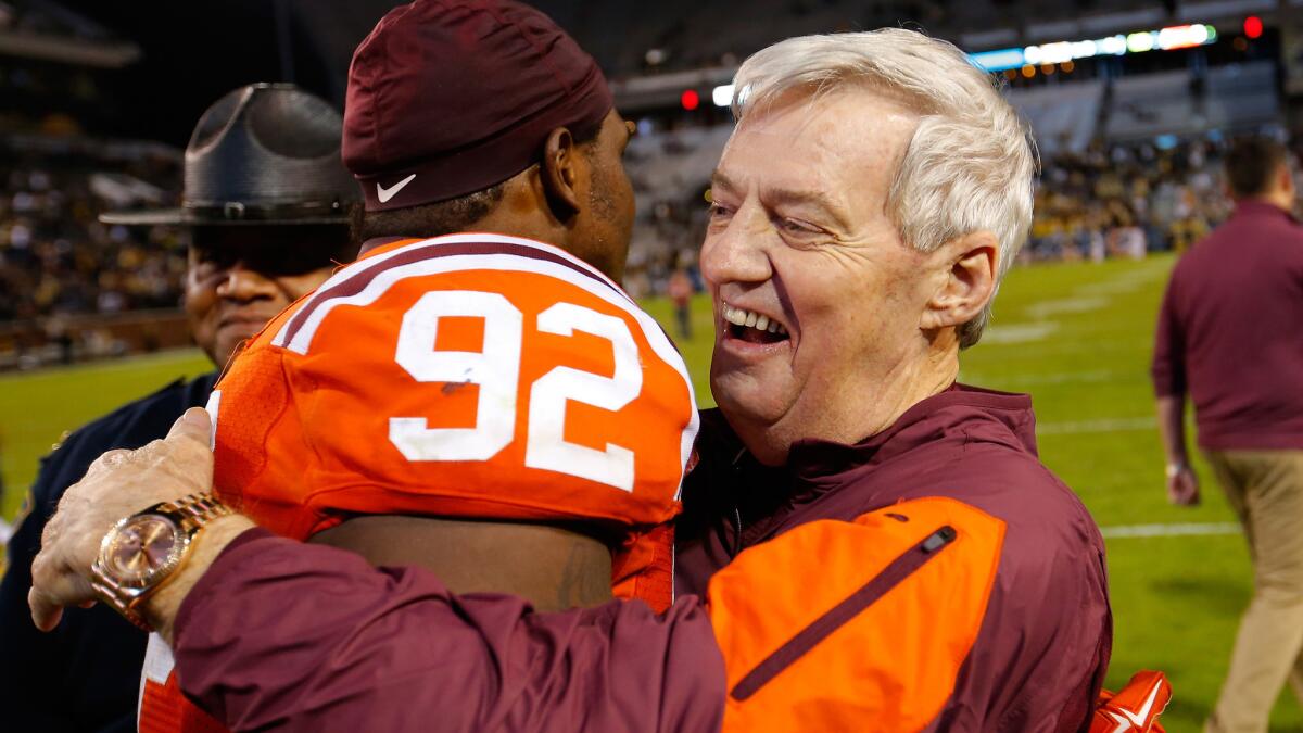 Virginia Tech Coach Frank Beamer celebrates a 23-21 win over Georgia Tech with defensive lineman Luther Maddy on Thursday night.