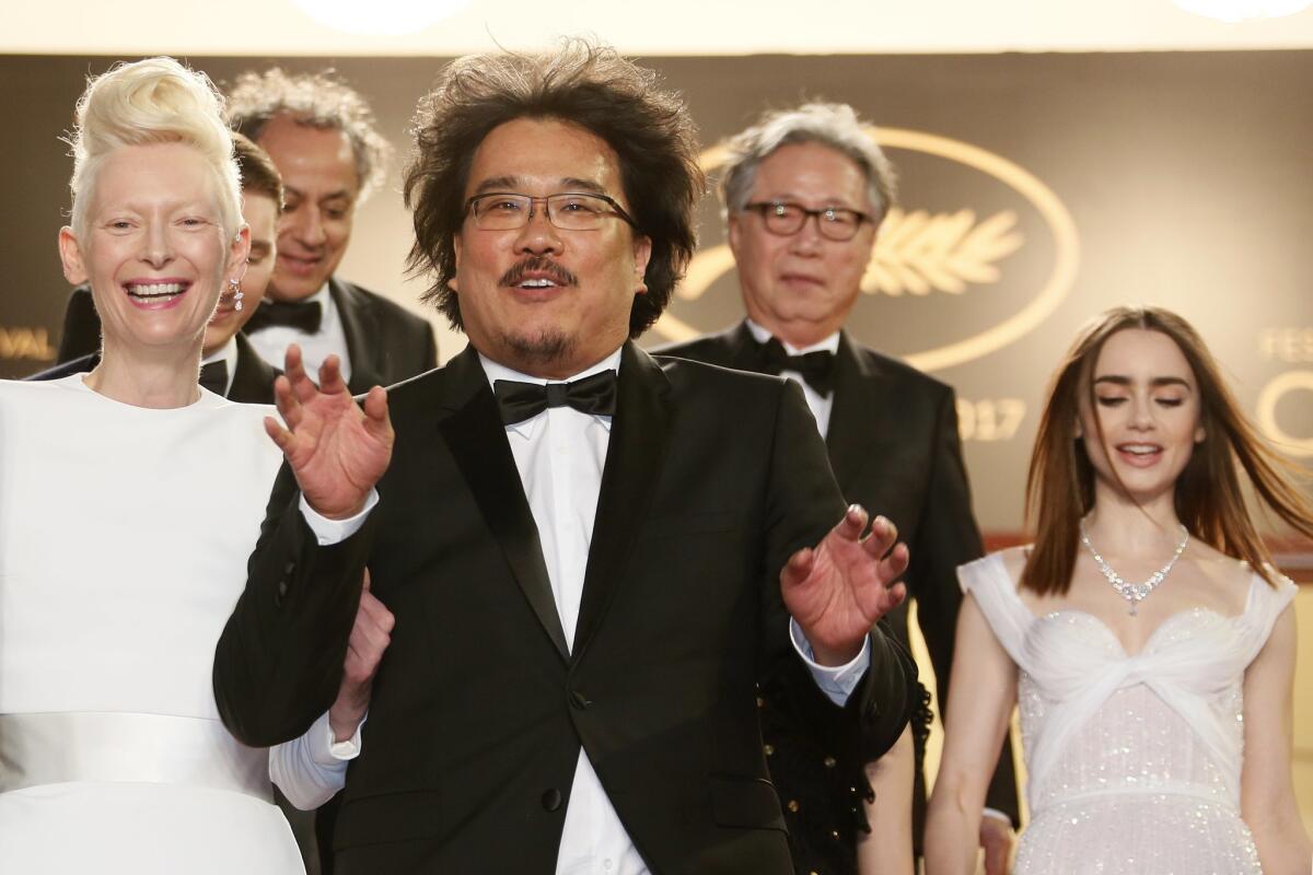 Actress Tilda Swinton, director Bong Joon-ho, actor Byung Heebong and actress Lily Collins at the premiere of 'Okja' during the 70th annual Cannes Film Festival.
