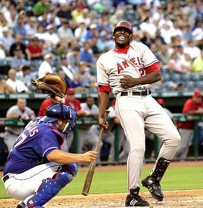 Los Angeles Angels' Vladimir Guerrero, right, reacts after being hit by a pitch from Texas Rangers' Vicente Padilla in the third inning.