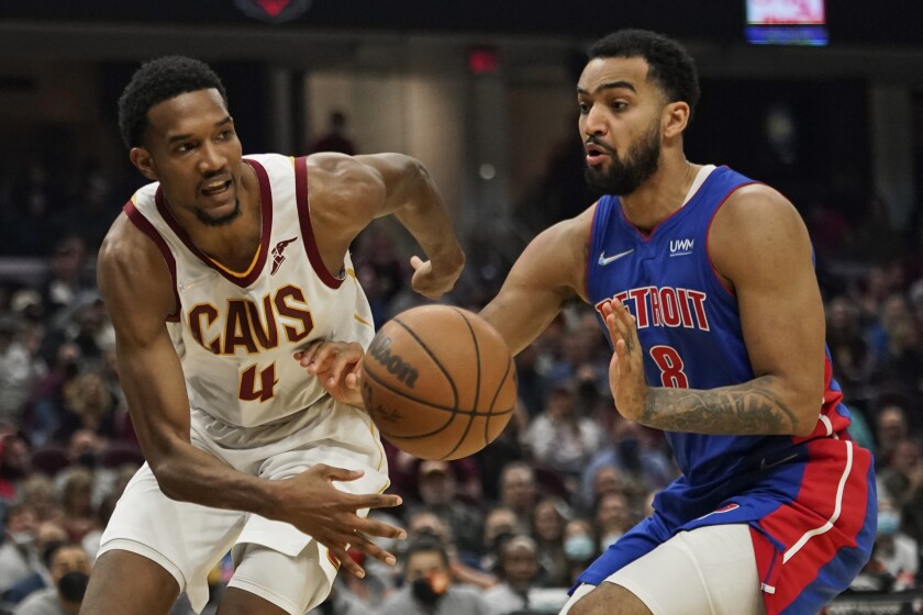 Cleveland Cavaliers' Evan Mobley (4) passes against Detroit Pistons' Trey Lyles (8) in the first half of an NBA basketball game, Friday, Nov. 12, 2021, in Cleveland. (AP Photo/Tony Dejak)