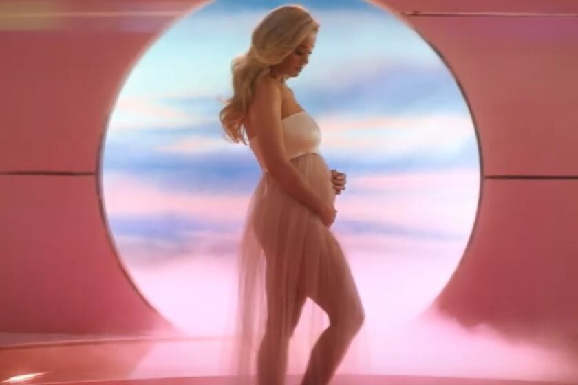 Katy Perry shows off a baby bump in a screen grab from her "Never Worn White" music video.