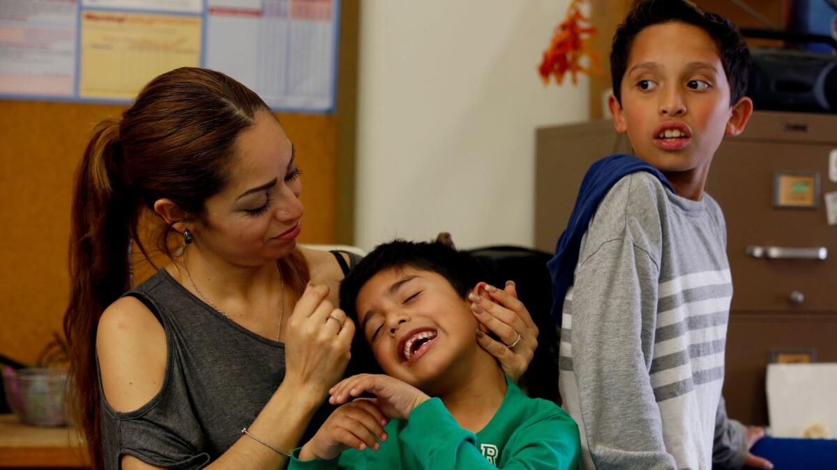 Liliana Sanchez de Saldivar, shown last week with her sons Jesus, 6, and Pablo, 10, lived at a Simi Valley church for three years to avoid deportation. (Francine Orr / Los Angeles Times)