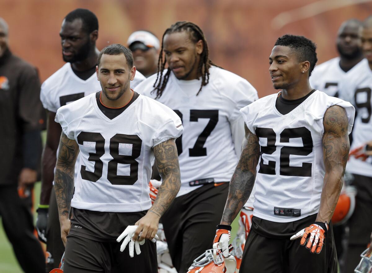 Members of the Cleveland Browns walk off the field after practice Tuesday.