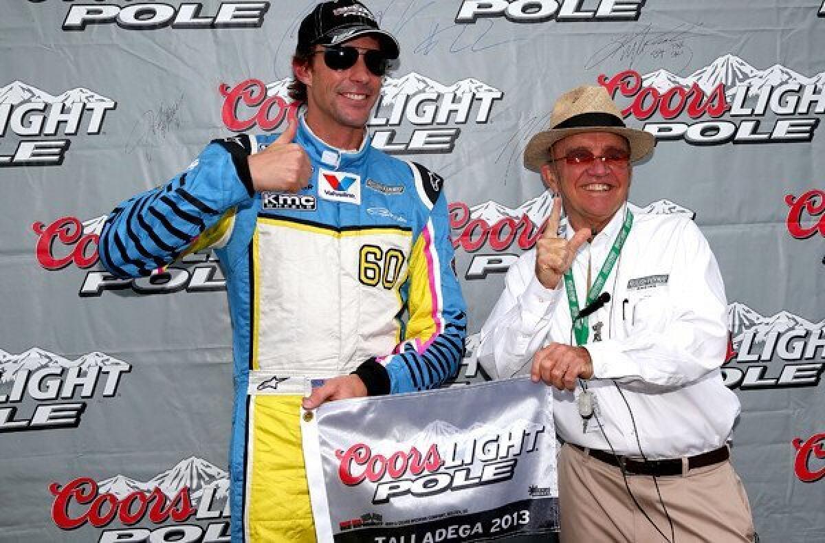 NASCAR driver Travis Pastrana and team owner Jack Roush celebrate after winning the Nationwide Series race pole at Talladega Superspeedway.