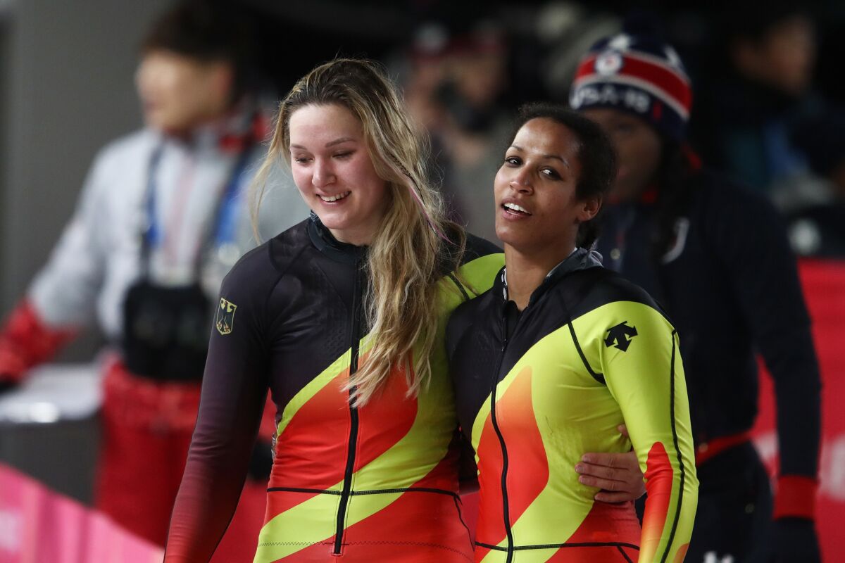 Mariama Jamanka, left, and Lisa Buckwitz of Germany celebrate winning gold.