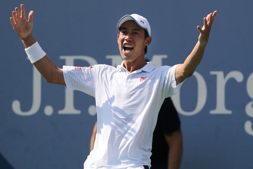 Kei Nishikori celebrates immediately after defeating Novak Djokovic in the U.S. Open semifinals on Saturday.