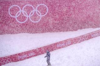 A course worker stands in the finish area of the men’s giant slalom