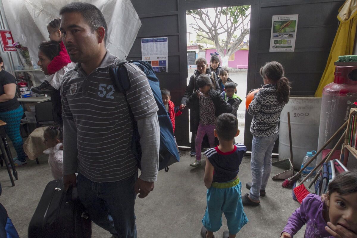 A dozen people enter the Juventud 2000 shelter in the Zone Norte neighborhood to seek shelter after arriving from south central México on May 22, 2019, in Tijuana.