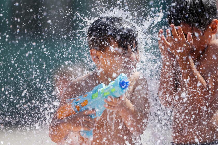 Azusa, CA, Monday, June 20, 2022 - Mason Gudiel, 5, of Glendora, stays cool at the Dalton Park water play area as temperatures soar on the last day of Spring. (Robert Gauthier/Los Angeles Times)