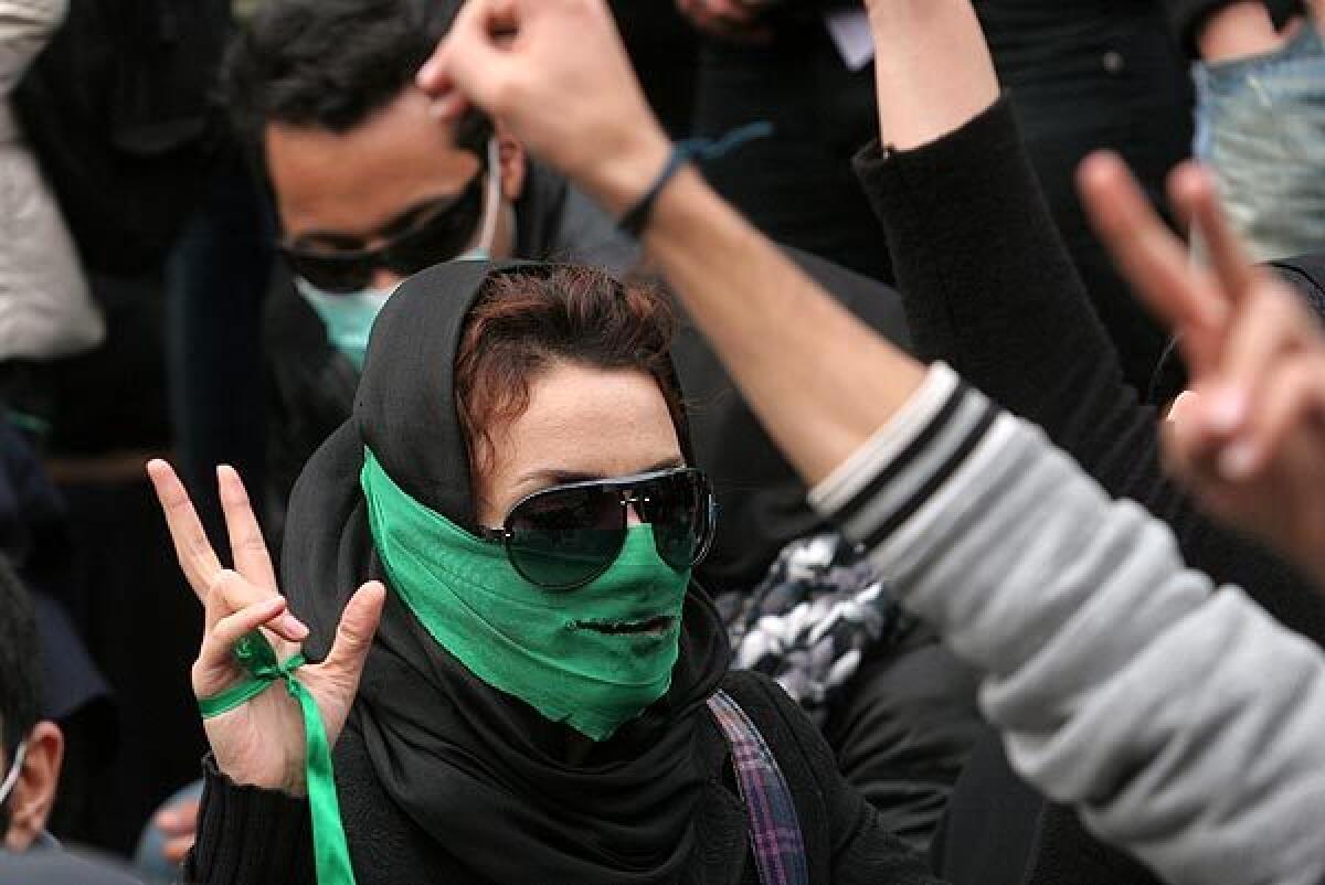 An Iranian opposition supporter gestures as she takes part in an anti-government demonstration at Tehran University in the Iranian capital on Jan. 13, 2020.