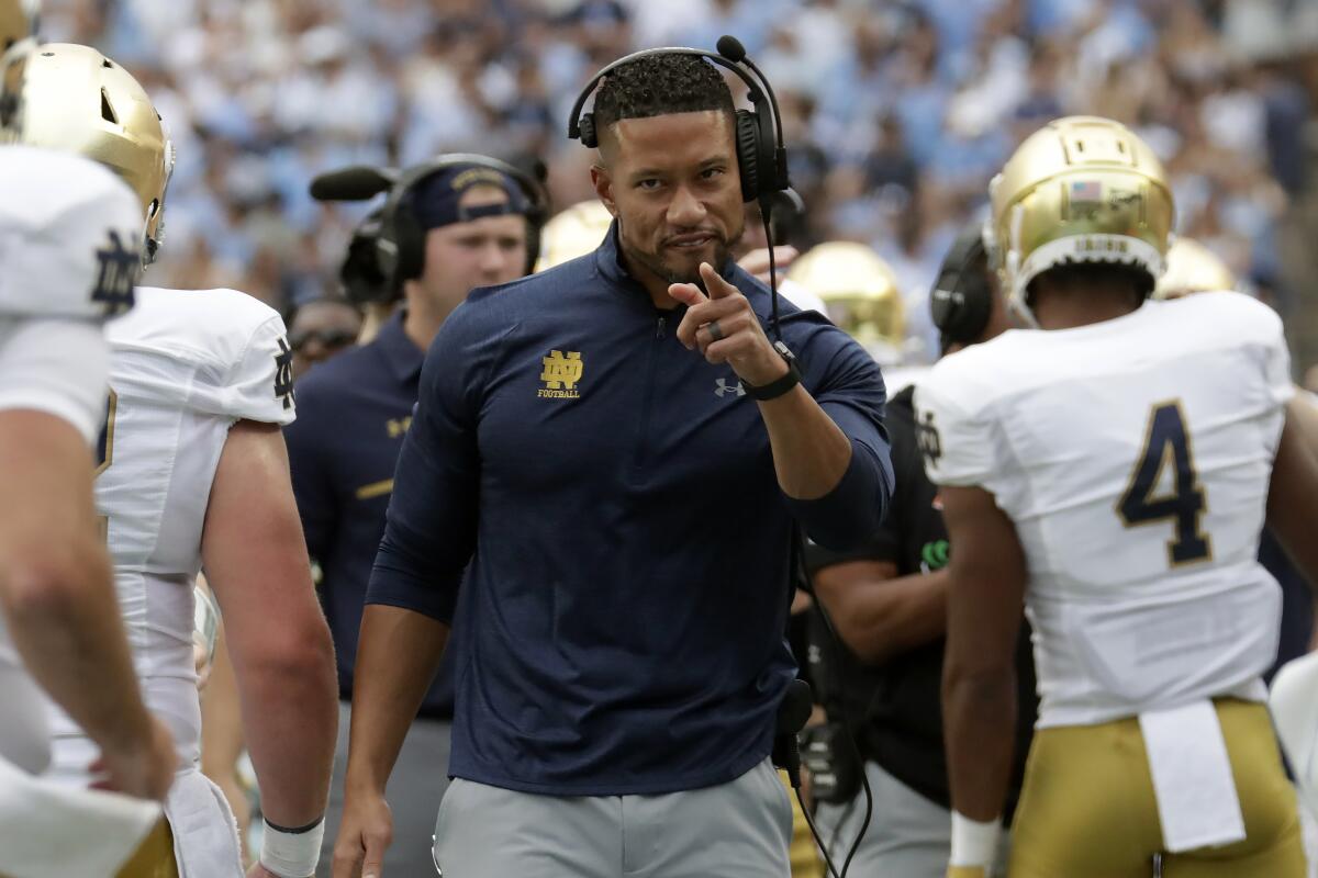 Notre Dame coach Marcus Freeman points to some players after the Irish scored