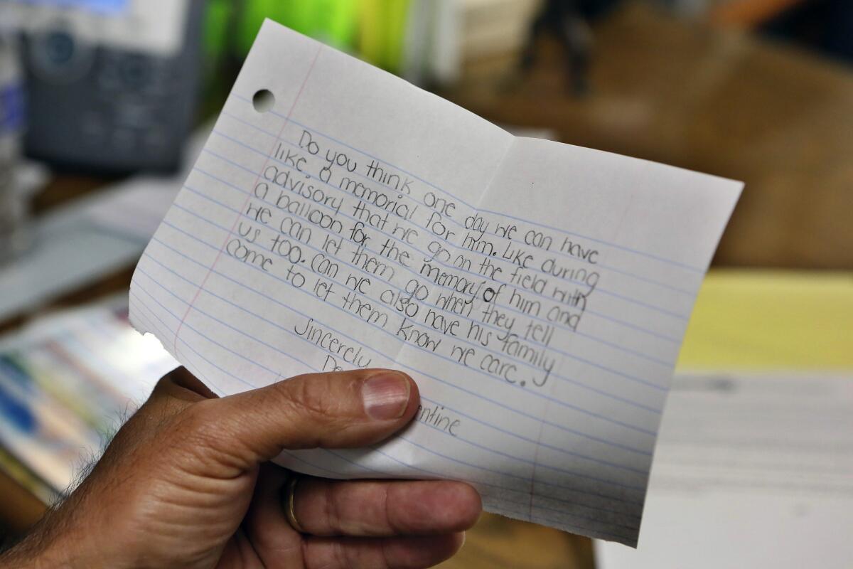 School Principal Rob Garza holds a note given to him by a classmate of Nigel Hardy. Many students said they want to memorialize their 13-year-old friend, who died in an apparent suicide.
