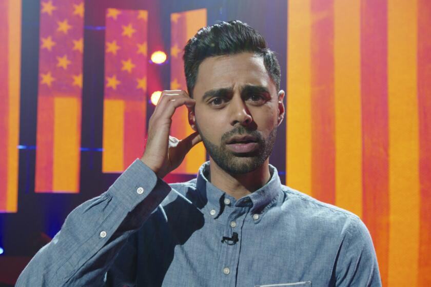 In this image released by Netflix, comedian Hasan Minhaj appears in a scene from his Netflix special, "Homecoming King." Minhaj is kicking off a 16-city North American tour starting in August and this fall will host his own weekly comedy show for Netflix. (Netflix via AP)