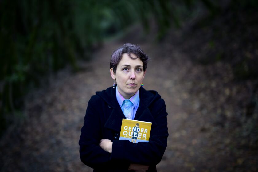 SANTA ROSA, CA - DECEMBER 13, 2022 - Maia Kobabe stands for a photo with her book "Gender Queer: A Memoir" at North Sonoma Regional Park in Santa Rosa, California on December 13, 2022. Kobabe's graphic novel about coming out as nonbinary is the most banned book in America. (Josh Edelson/for the Times)