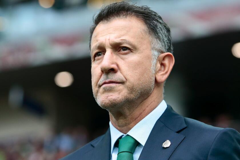 FILE - In this July 2, 2017, file photo, Mexico coach Juan Carlos Osorio waits for the kick-off of the Confederations Cup, third place soccer match between Portugal and Mexico, in Moscow, Russia. Mexico coach Juan Carlos Osorio has been effectively banned from the Gold Cup by FIFA for insulting match officials. FIFA banned Osorio for six matches on Friday, July 7, 2017, for his behavior during the Confederations Cup third-place game last Sunday, when Mexico lost to Portugal 2-1. (AP Photo/Denis Tyrin, File)