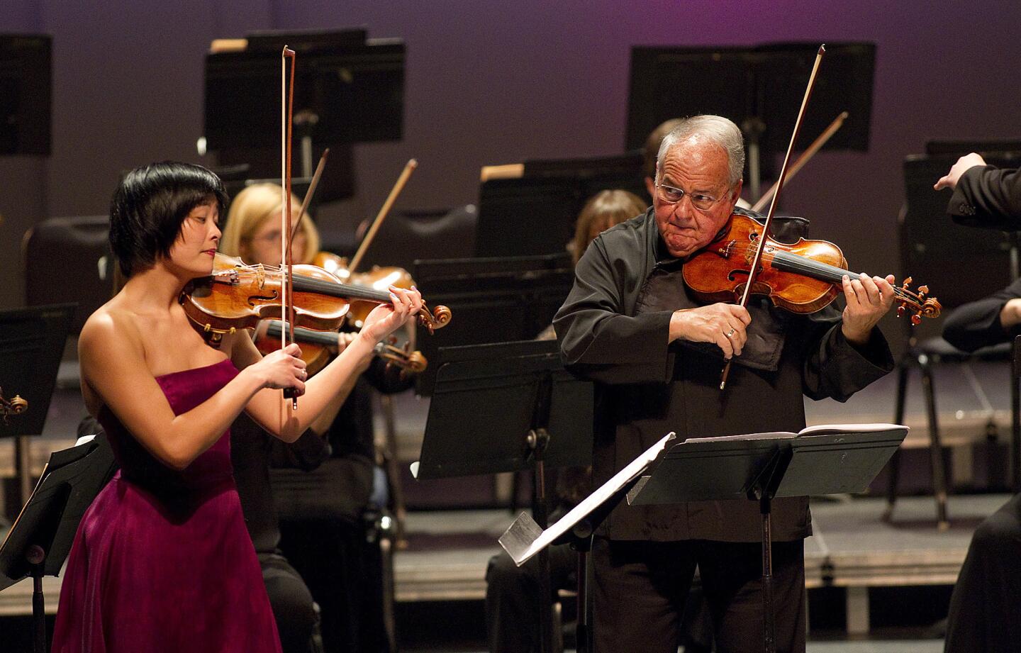 Violinists Jennifer Koh, left, and Jaime Laredo, right, perform Anna Clyne's "Prince of Clouds" with the Los Angeles Chamber Orchestra at the Alex Theatre.