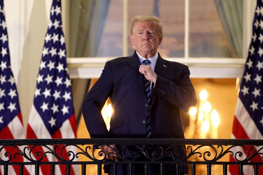 WASHINGTON, DC - OCTOBER 05: U.S. President Donald Trump gestures on the Truman Balcony after returning to the White House from Walter Reed National Military Medical Center on October 05, 2020 in Washington, DC. Trump spent three days hospitalized for coronavirus. (Photo by Win McNamee/Getty Images)