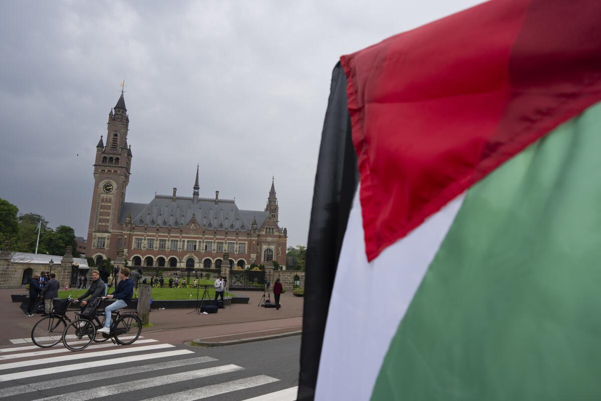 The Peace Palace in The Hague with a Palestinian flag in the near foreground