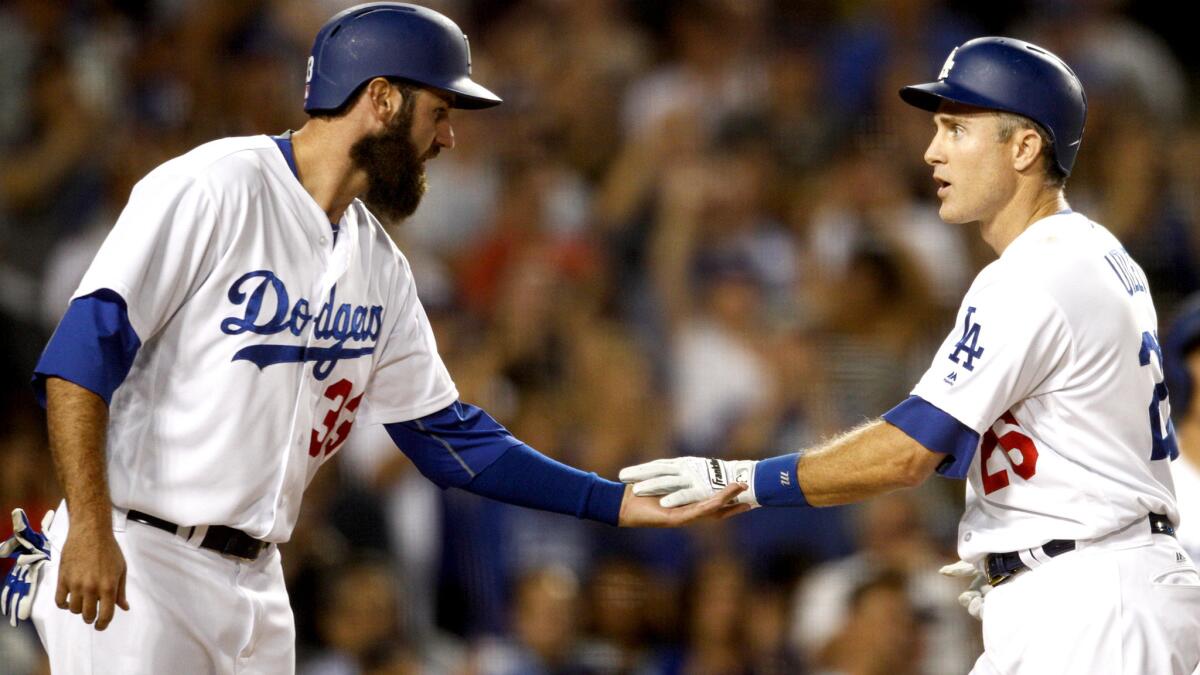 Dodgers decond baseman Chase Utley (26) is congratulated by teammate Scott Van Slyke (33) after hitting a home run against the Diamondbacks on Friday night.