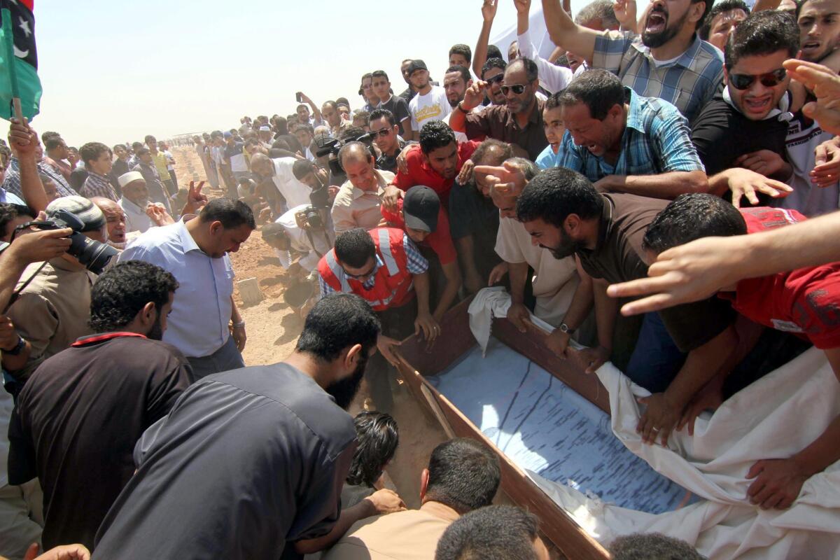 Libyans on Saturday carry the coffin of lawyer and prominent activist Abdel-Salam al-Mesmari, who was shot dead a day earlier, in Benghazi, Libya.