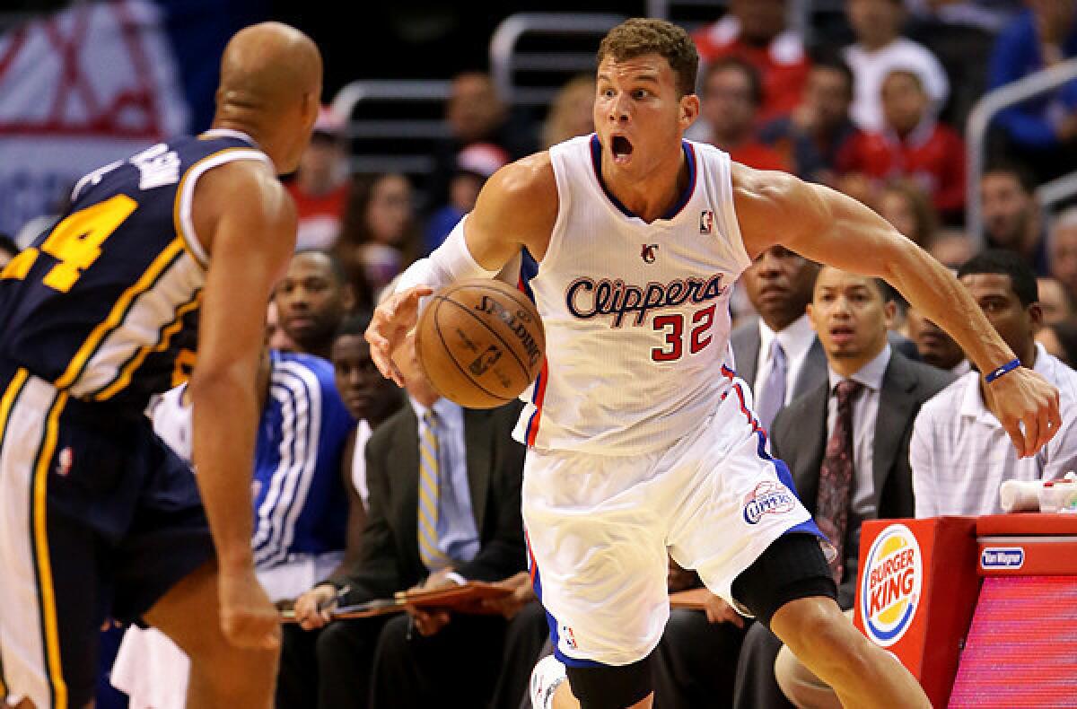 Clippers power forward Blake Griffin brings the ball upcourt against Utah Jazz forward Richard Jefferson during a preseason game at Staples Center.