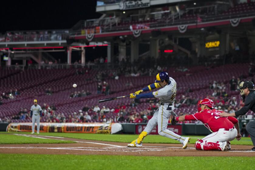 Milwaukee Brewers' Christian Yelich hits a two-run home run during the first inning of a baseball game against the Cincinnati Reds in Cincinnati, Wednesday, April 10, 2024. (AP Photo/Aaron Doster)