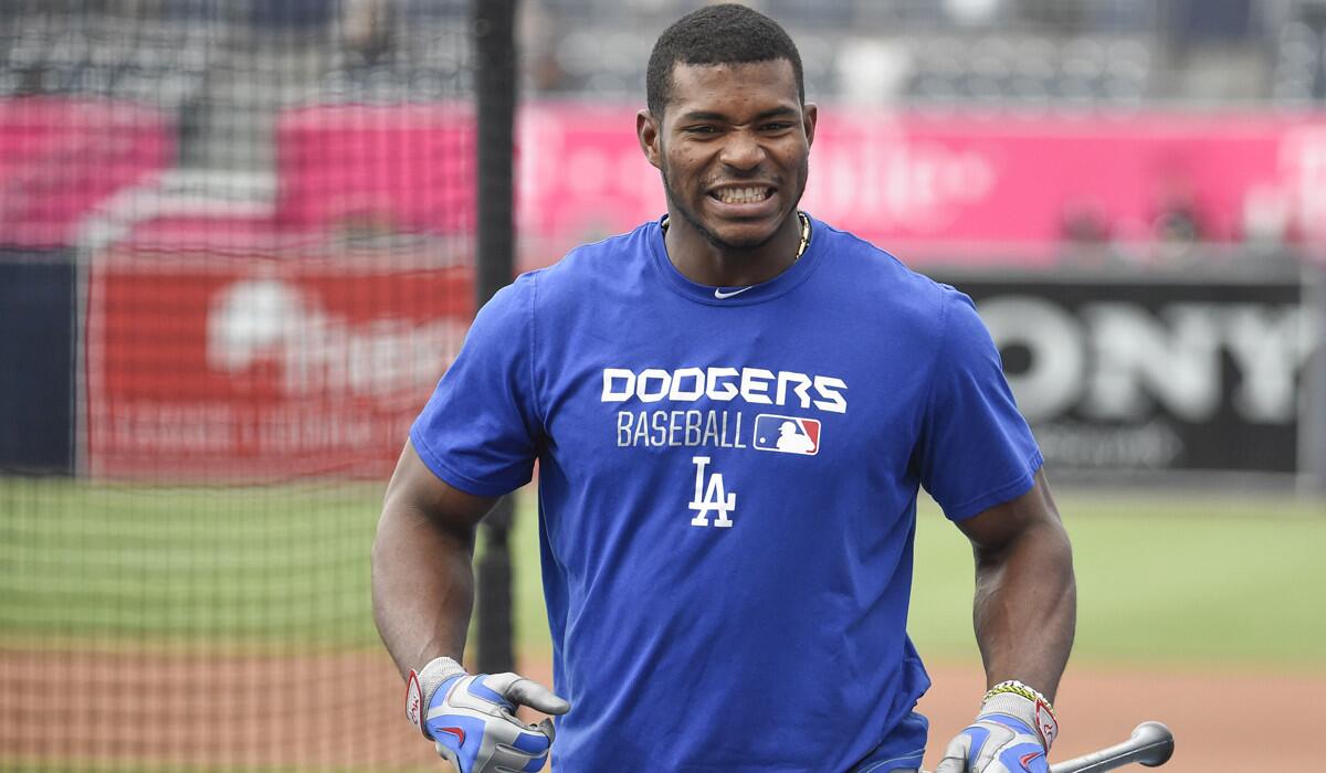 Dodgers outfielder Yasiel Puig warms up before a game against the San Diego Padres on Thursday.
