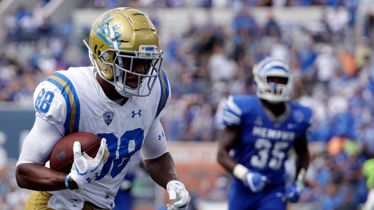 UCLA tight end Austin Roberts scores a touchdown on a 22-yard pass against Memphis