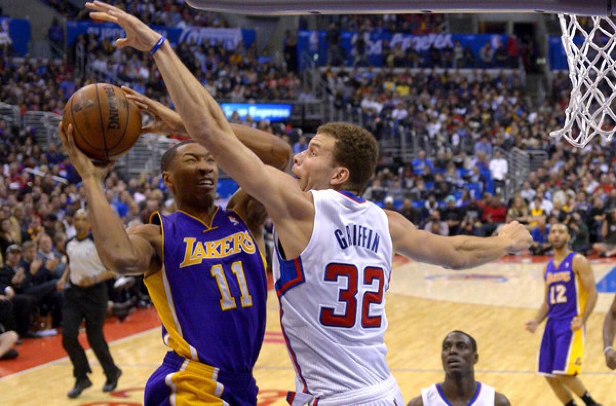 Clippers power forward Blake Griffin tries to block a shot by Lakers forward Wesley Johnson during a game earlier this season.