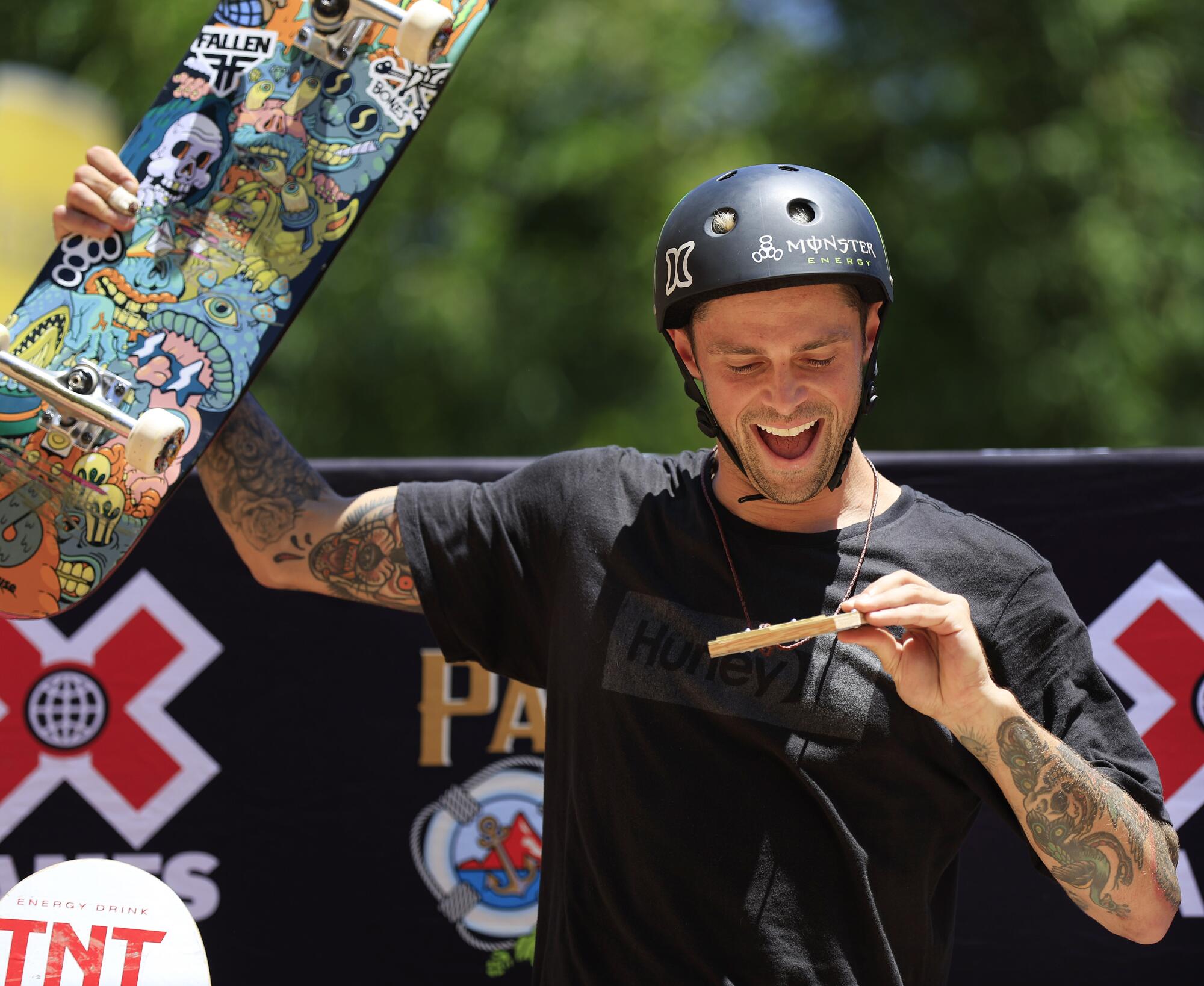 Elliot Sloan looks a his gold medal after he won the skate vert trick competition in the X Games.