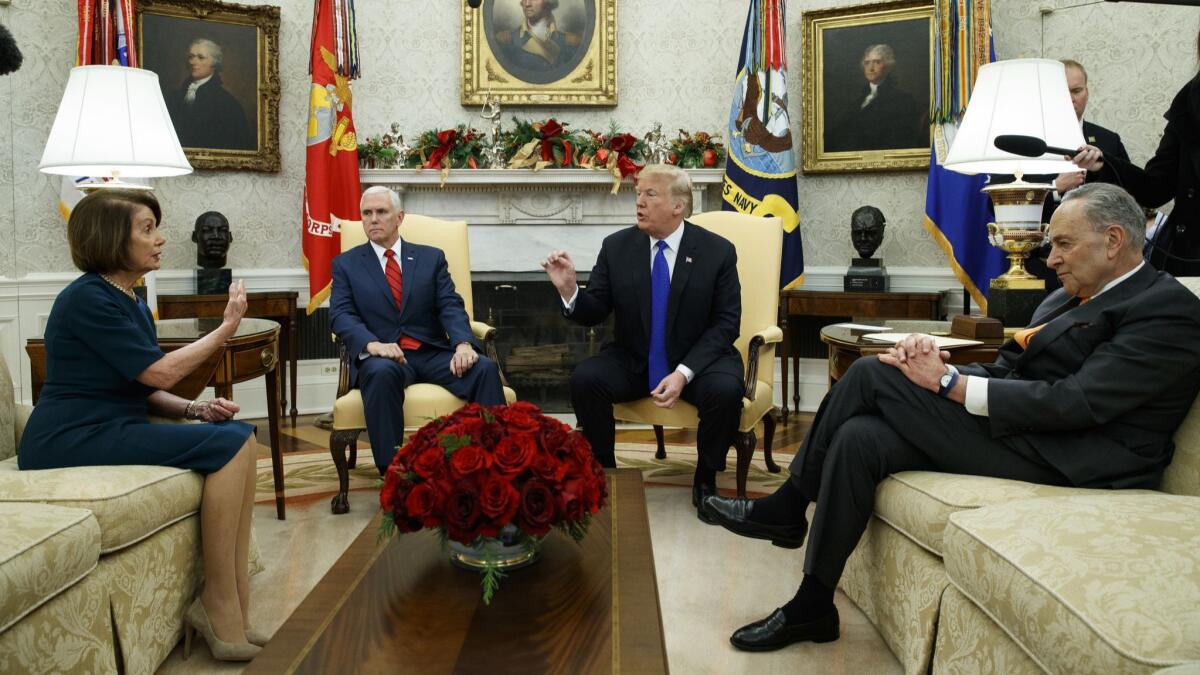 House Minority Leader Rep. Nancy Pelosi, D-Calif., Vice President Mike Pence, President Donald Trump, and Senate Minority Leader Chuck Schumer, D-N.Y., argue during a meeting in the Oval Office in Washington on Dec. 11.