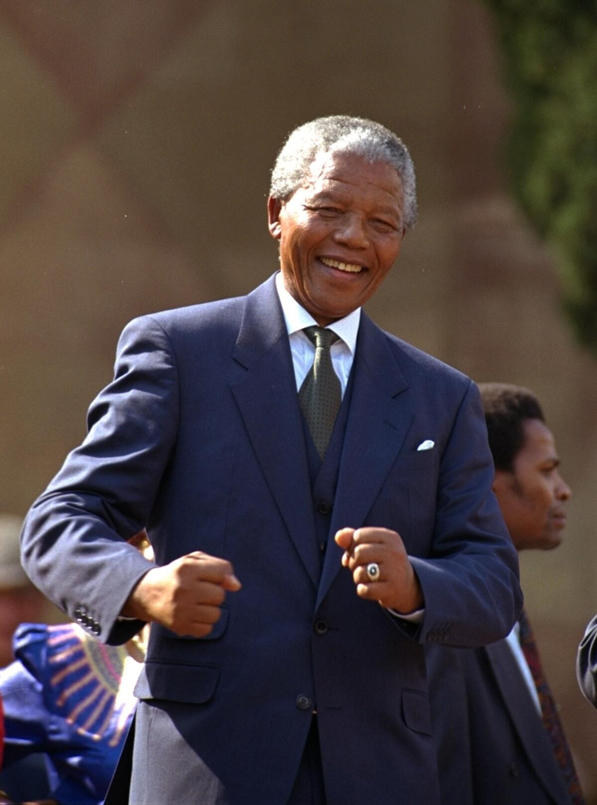 Nelson Mandela dances at a celebration concert following his inauguration as president of South Africa
