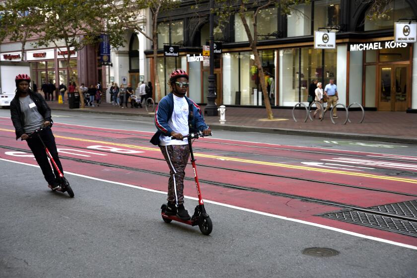 SAN FRANCISCO, CALIFORNIA - SEPTEMBER 12, 2018: Tourists visiting San Francisco, California, ride their rented Scoot electric scooters down Market Street. (Photo by Robert Alexander/Getty Images) ** OUTS - ELSENT, FPG, CM - OUTS * NM, PH, VA if sourced by CT, LA or MoD **