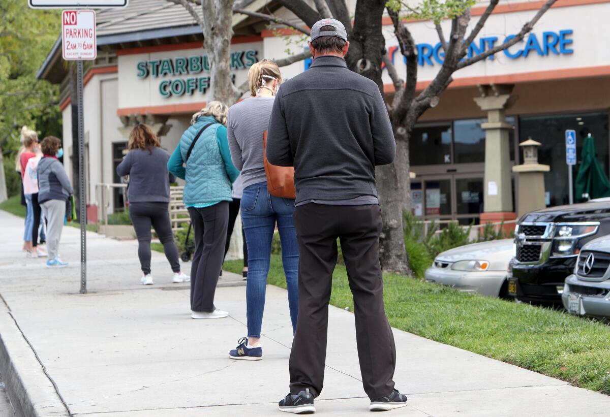 A long line of shoppers stood out to Gould Avenue, where wait times were estimated at 45 minutes, to get into Trader Joe's grocery store on Foothill Boulevard in La Ca?ada Flintridge on Tuesday, April 7, 2020.