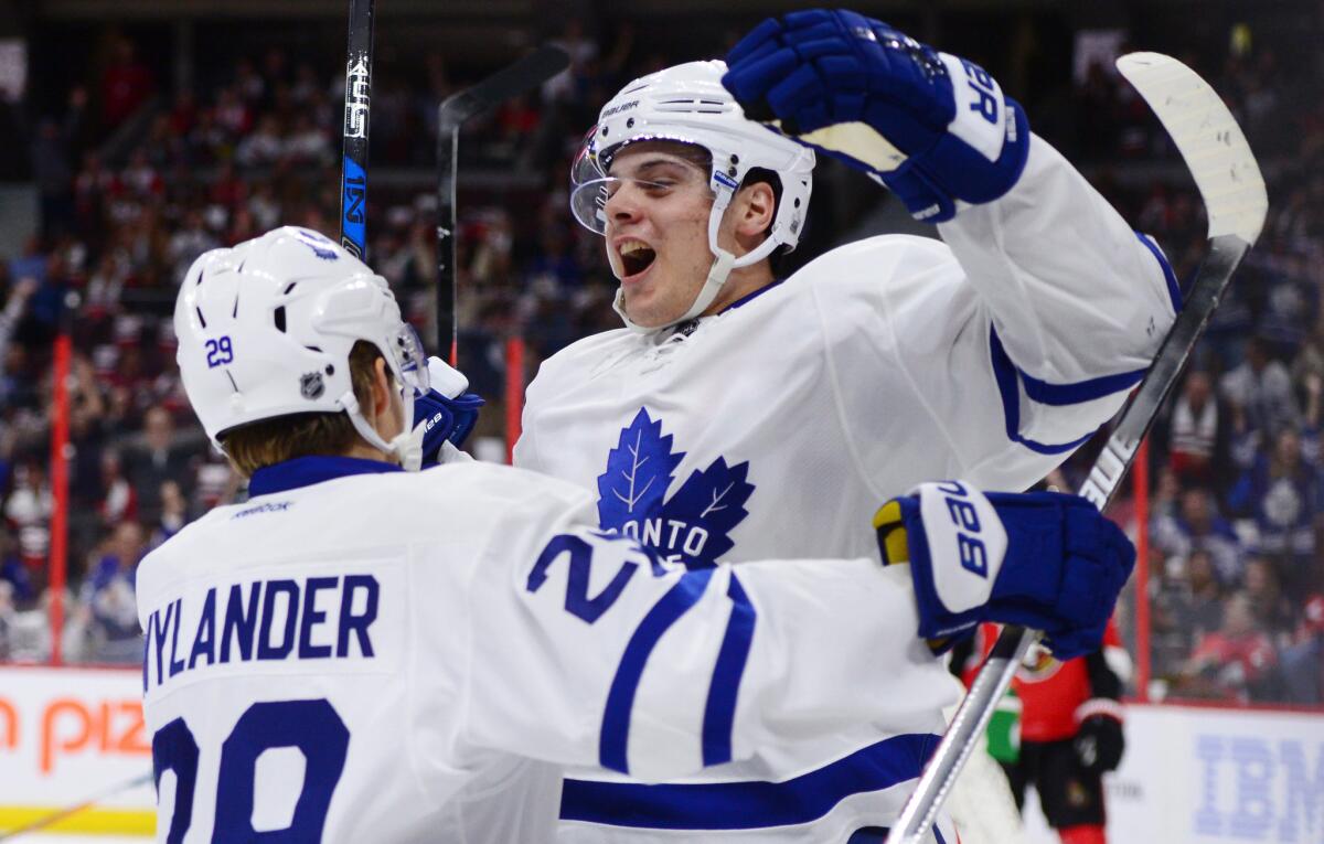 Maple Leafs center Auston Matthews, right, celebrates a first-period goal against the Ottawa Senators with teammate William Nylander on Oct. 12.