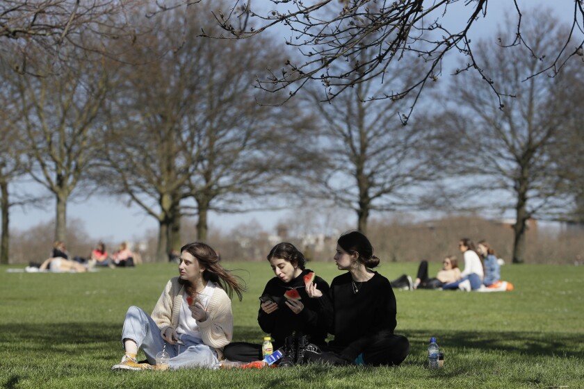 FILE - In this Monday, March 29, 2021 file photo, groups of people picnic in Hyde Park, London, as lockdown easing begins. British Prime Minister Boris Johnson is expected to give the go-ahead for that much-missed human contact when he announces the next round of lockdown easing later Monday May 10, 2021, in the wake of a sharp fall in new coronavirus infections. (AP Photo/Kirsty Wigglesworth, File)