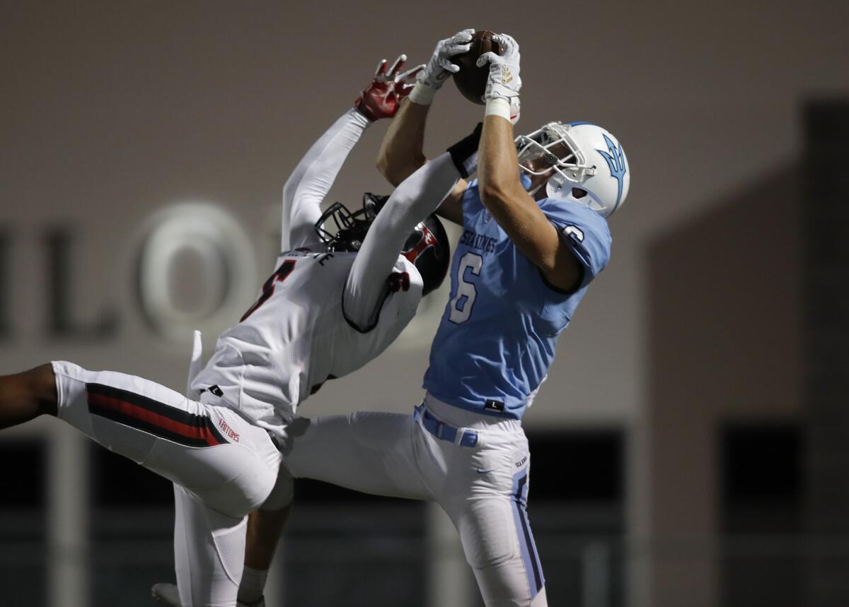 Corona del Mar's John Humphreys, right, catches a two-yard touchdown against San Clemente's Nick Billoups during the first quarter of a nonleague home game at Newport Harbor High on Thursday.