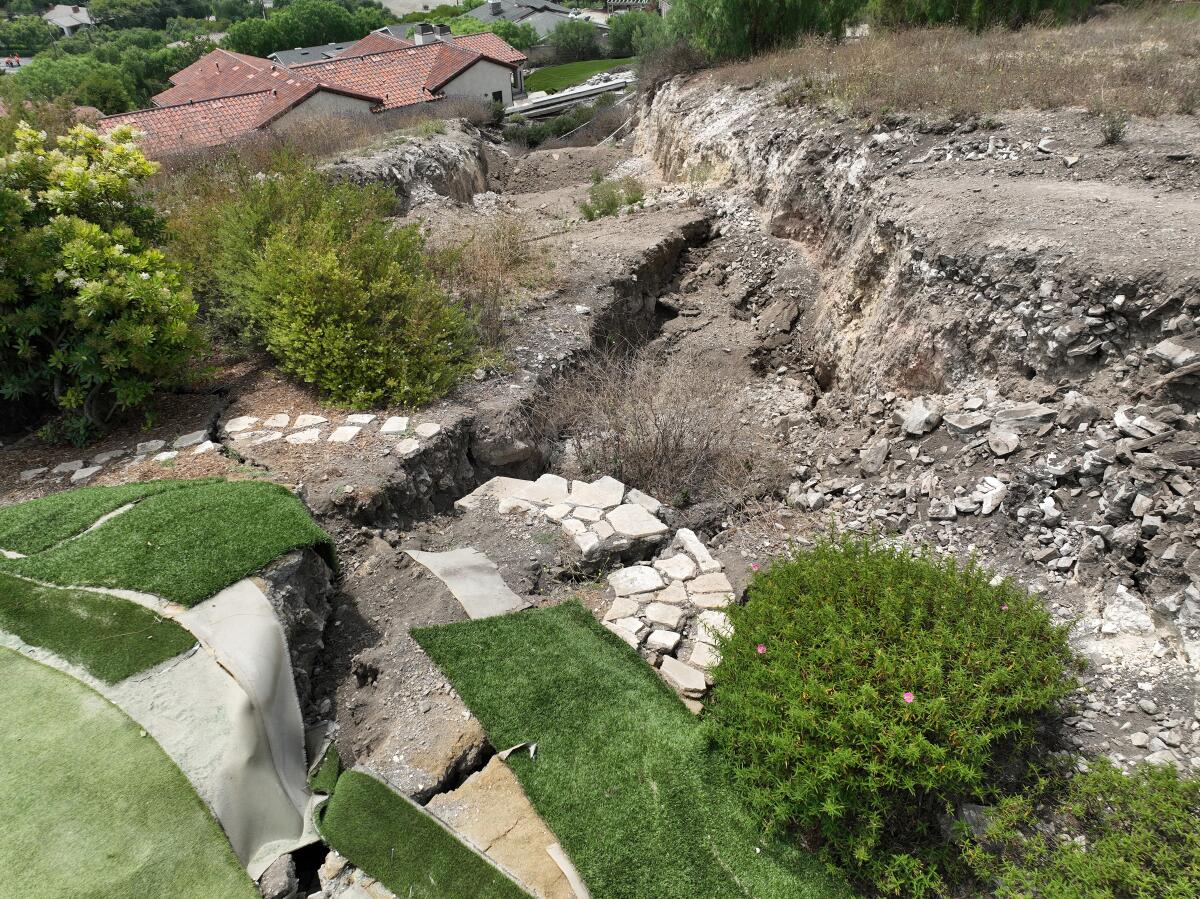 An aerial view of a large fissure that has damaged a Portuguese Bend putting green and home in Rancho Palos Verdes.