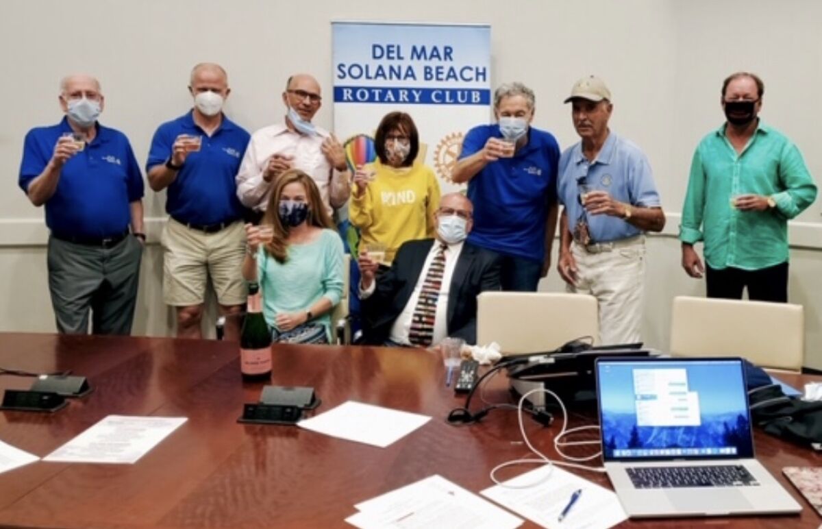 Del Mar-Solana Beach Rotary Club members making a toast at the recent Celebration of Giving.