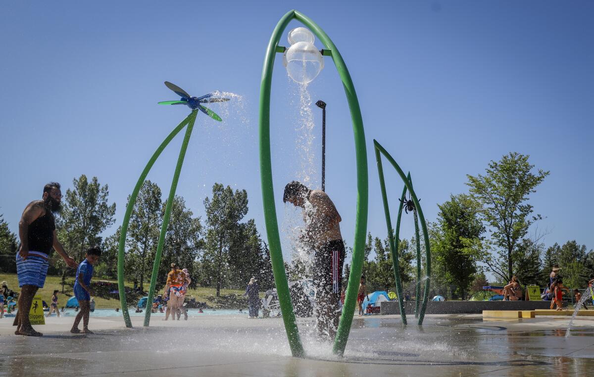 Man standing under spray at a water park