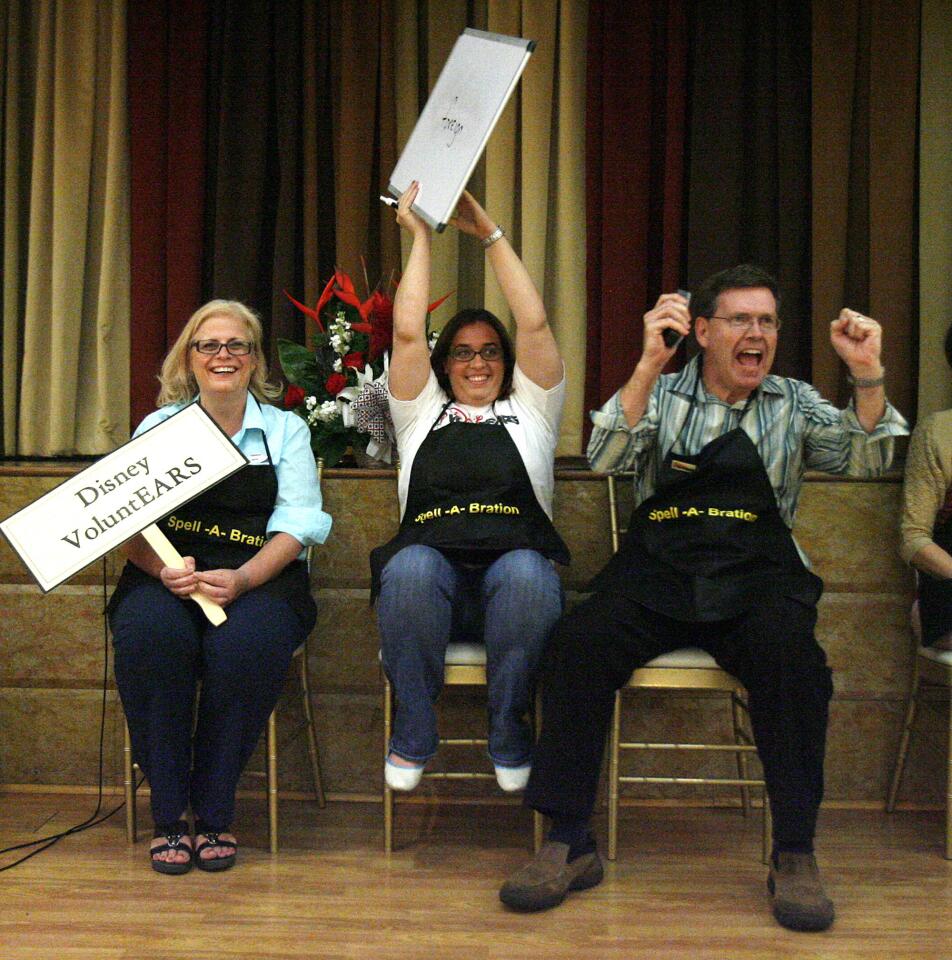 Team VoluntEARS of Silvia Mancini, Katy Densmore and Brad Adams smile after spelling "foreign" correctly at the Spell-A-Bration by the Friends of the Burbank Public Library at the Ritz Banquet Hall in Burbank on Thursday, April 25, 2013. The event is annual, but until the spelling bee, the contest has been a game of trivia.
