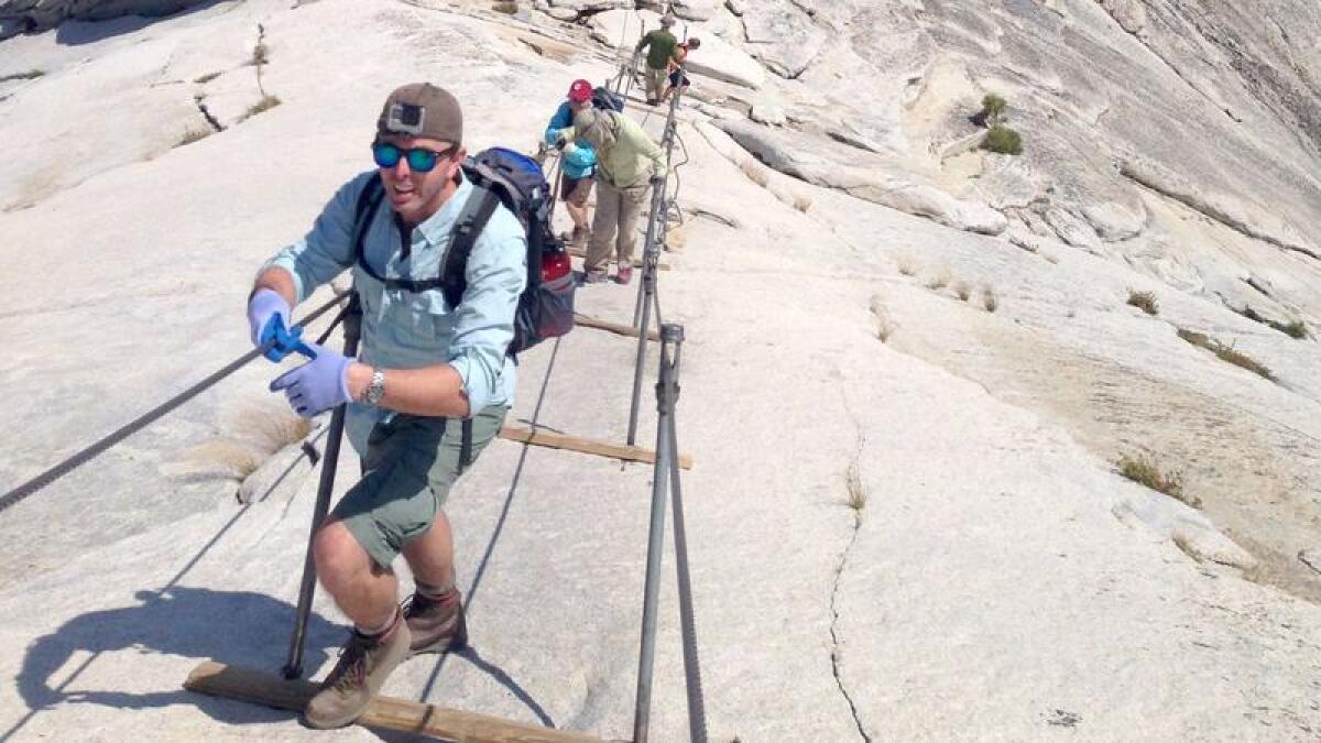 Hikers make their way up the Half Dome Cables August 11, 2015. 