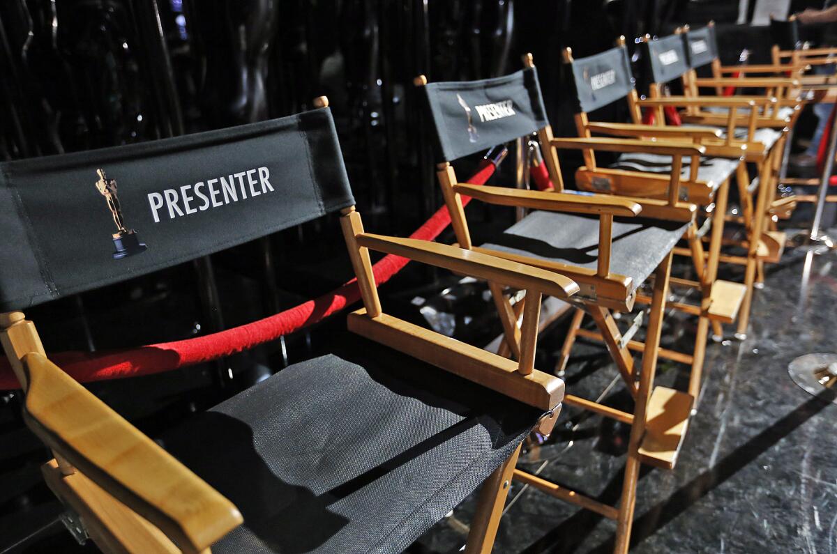 Director's chairs lined up backstage for the presenters at the 2015 Oscars.