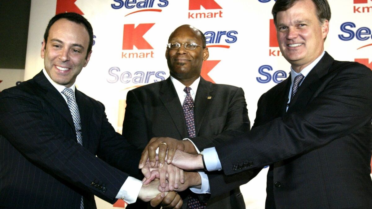 Edward Lampert, chairman of Kmart, left, with Aylwin Lewis, president of Kmart, center, and Alan Lacy, CEO of Sears at the announcement of a merger between Kmart and Sears in 2004. Kmart was throwing off cash when Lampert masterminded the deal, but losses soon started piling up.