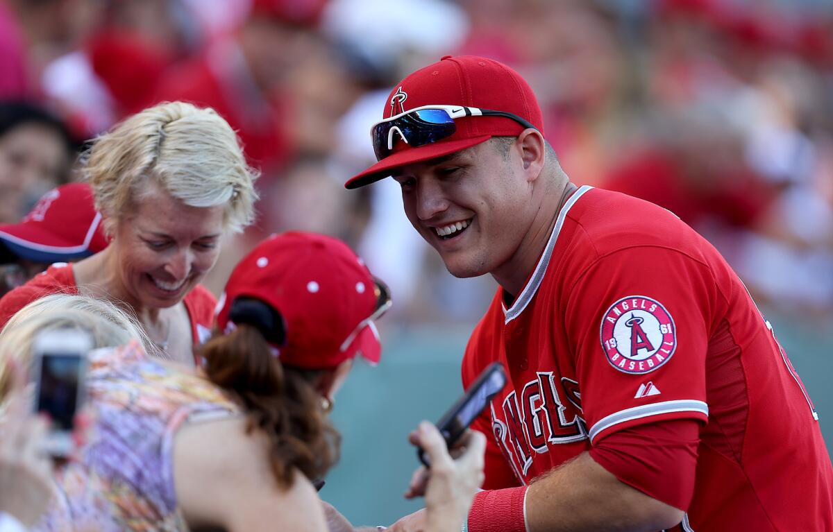 Angels' Mike Trout interacts with fans before a game against Oakland on Sept. 30.