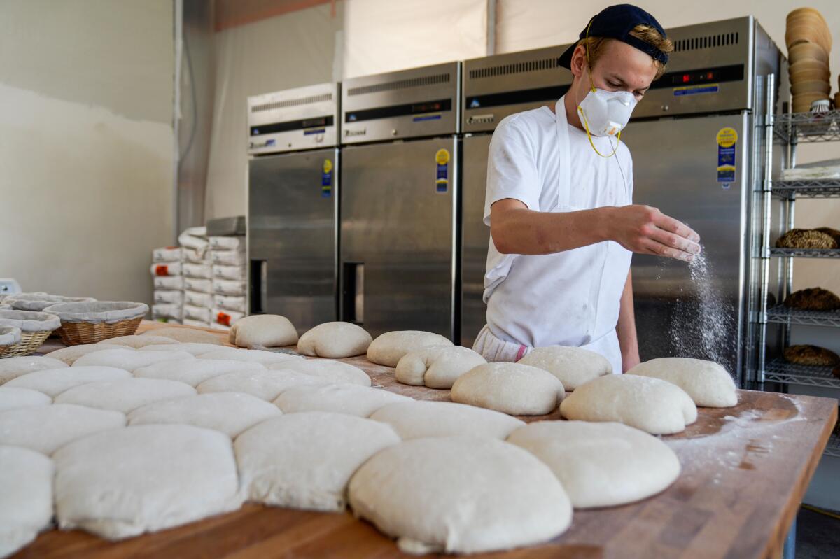 Jyan Isaac Horwitz sprinkles flour on dough